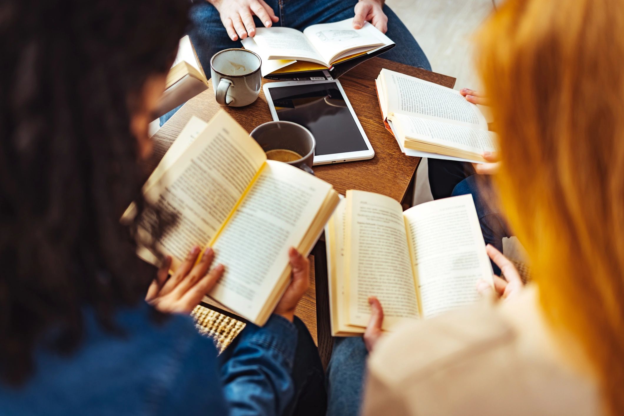 Adult students studying together in a library