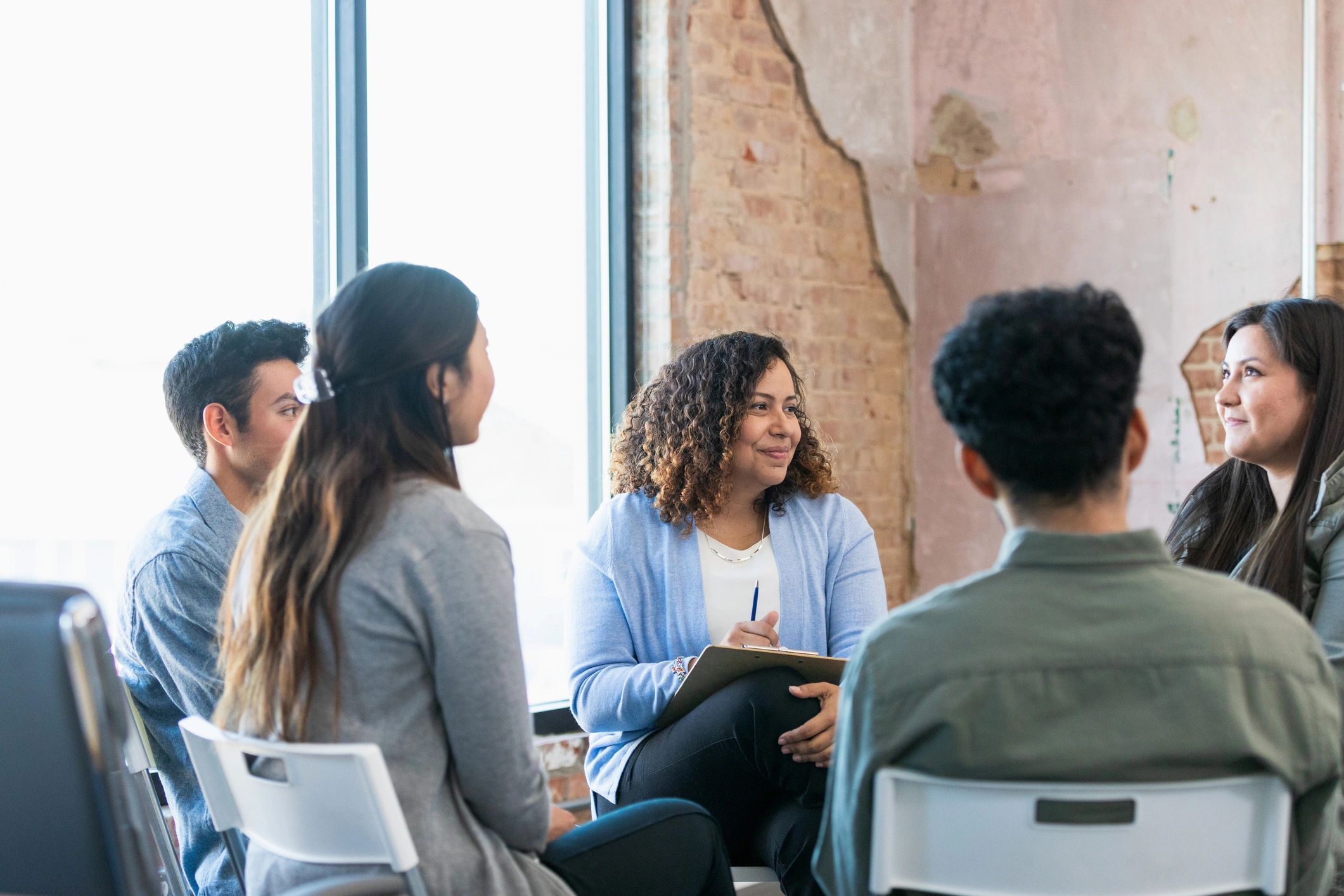 Woman sharing in a group while others listen attentively