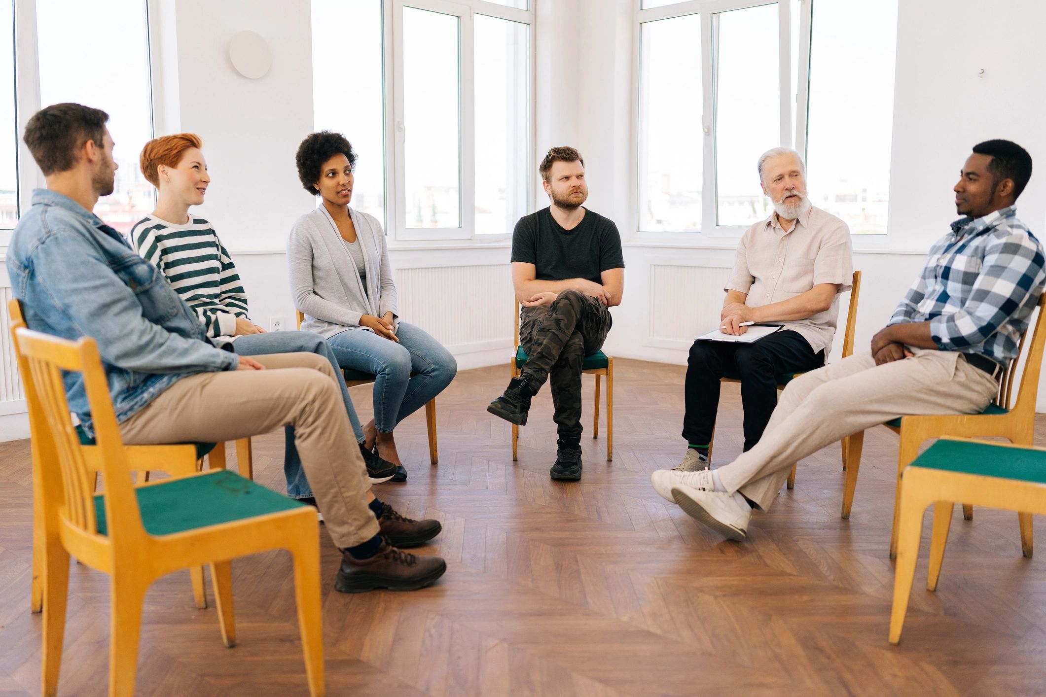 Diverse group seated in a circle during a reflective discussion